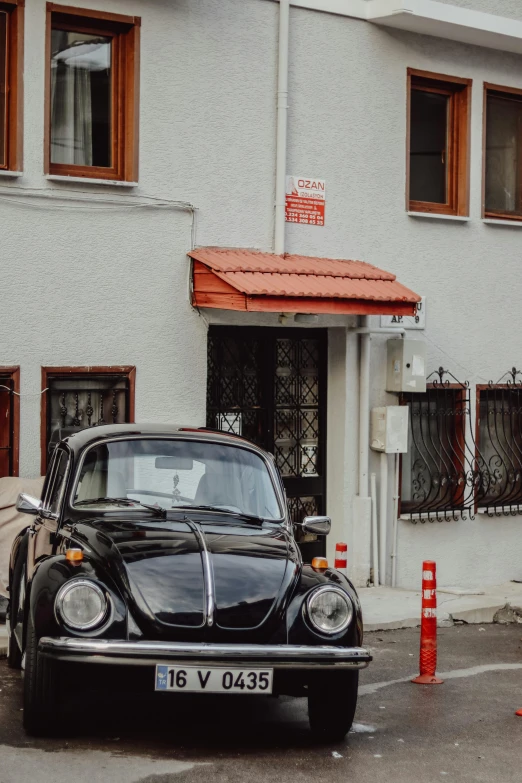 a vintage car parked in front of a house