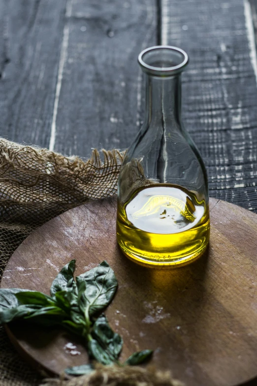 a glass bottle with some oil on top