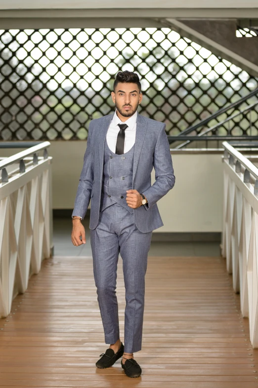 man walking across wooden bridge in suit and tie