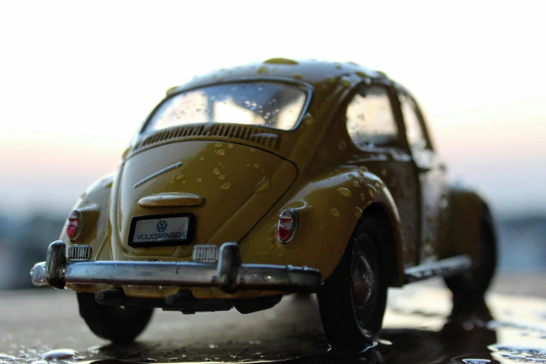 the yellow toy car is parked on the side of the street