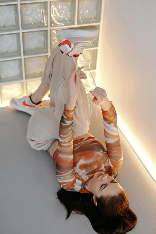 a woman is laying down on the ground in a room