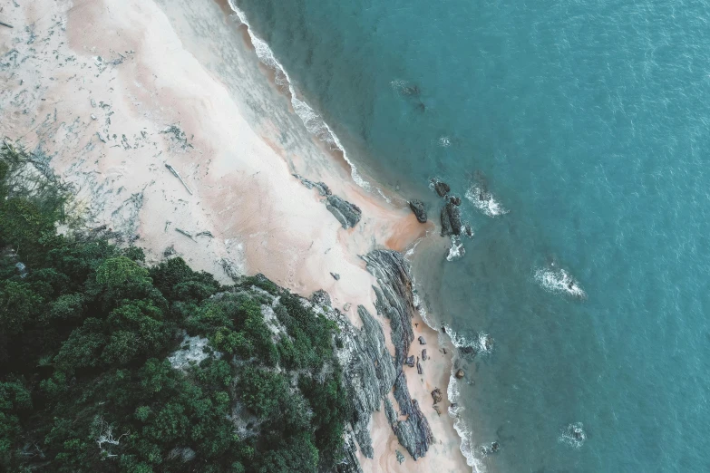 a aerial view of an ocean beach and a small island