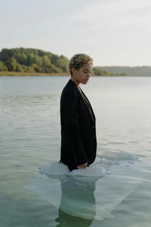 a person in a suit floating on top of a large body of water