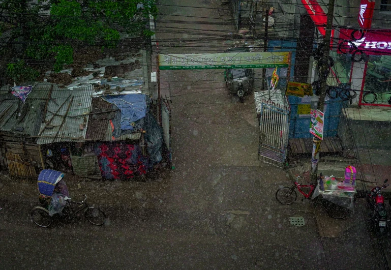 a city street scene with rain and umbrellas on the sidewalks