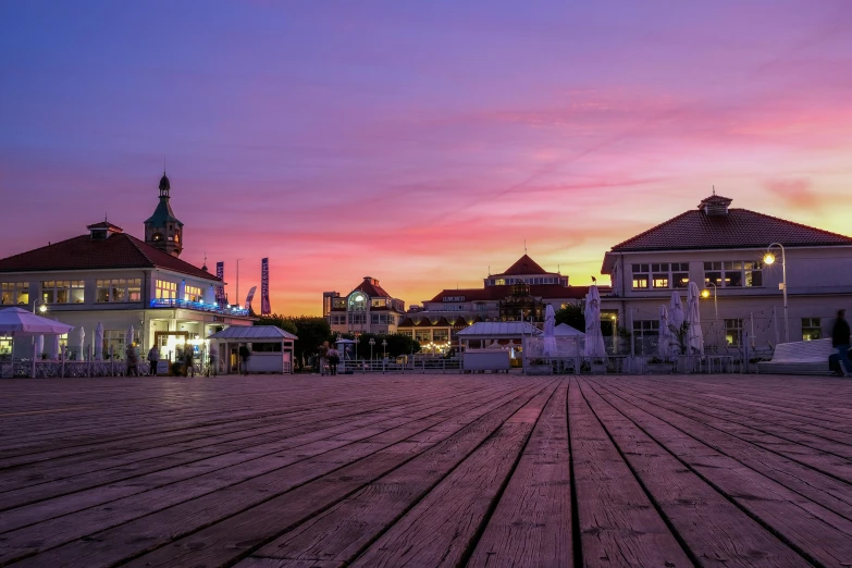 a purple sky with lights of buildings in the distance