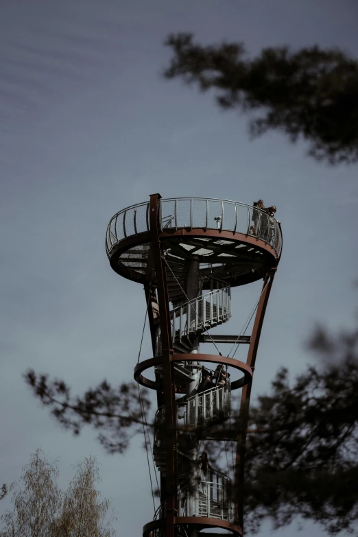 a spiral stairway in front of some trees