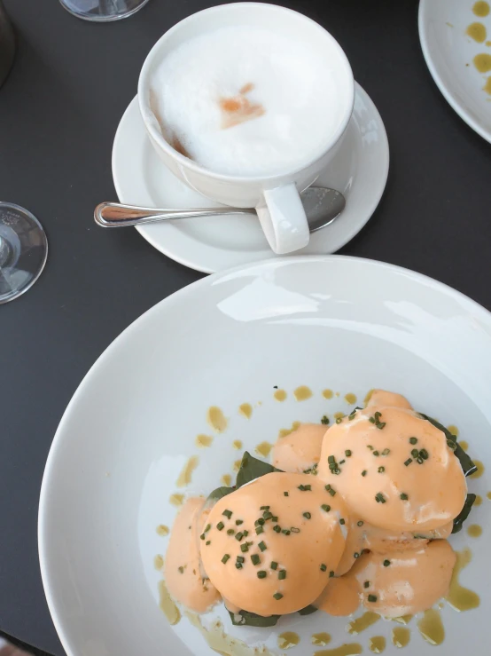 three white plates on a table with food and drinks