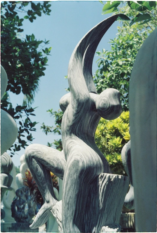 a close up of a statue with trees in the background