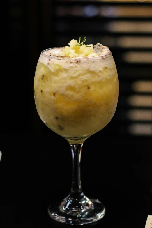 a close - up view of a cocktail with ice and a garnish on the rim