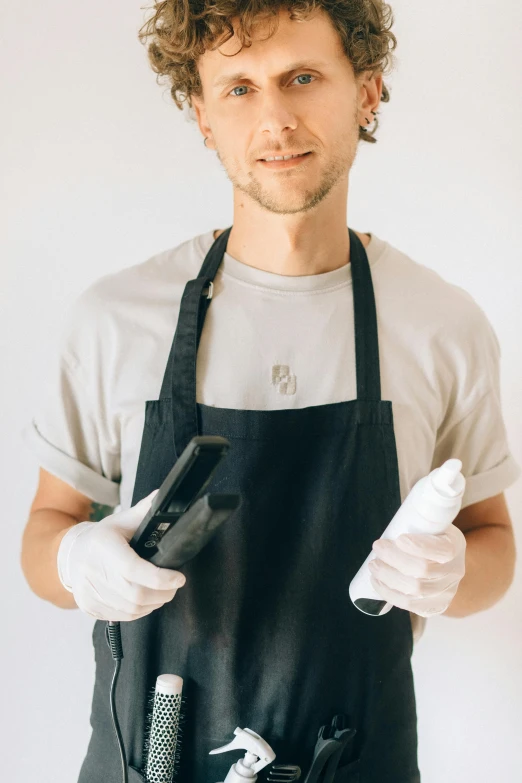 a man in an apron holding a camera