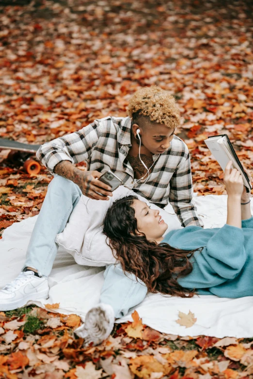 two women laying down with their phones in hand