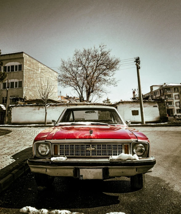 an old car is parked on the side of the road