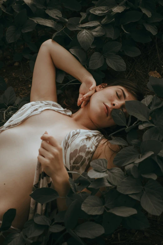 a woman with  laying on leaves