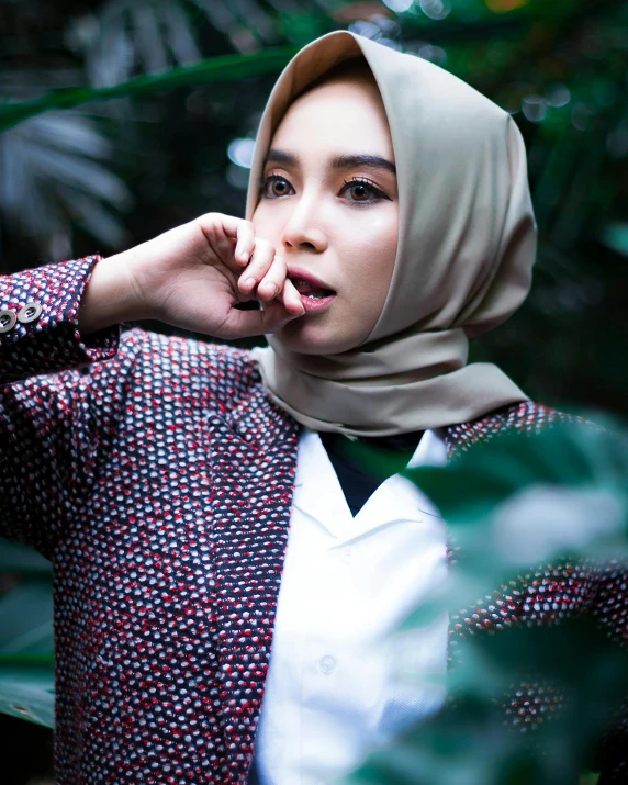 a young woman with a head covering poses