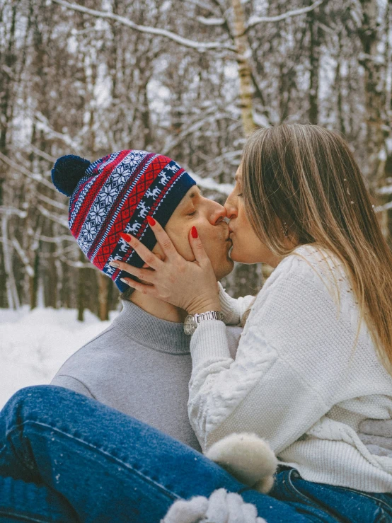 a man and woman kissing each other outside