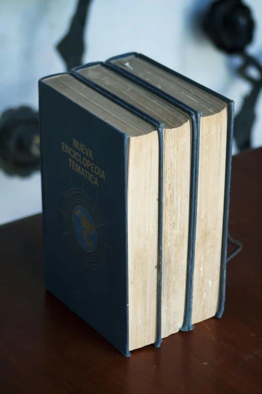 two books with a picture of a woman on one of them are sitting on a table