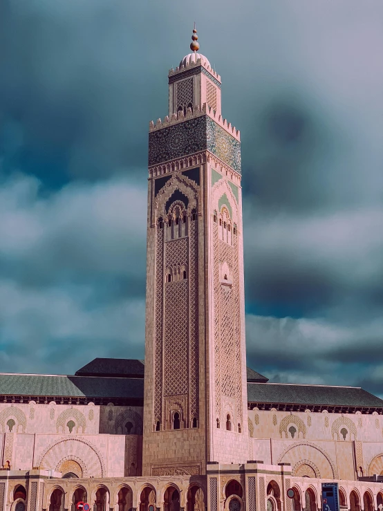 a large white clock tower on the corner of a building