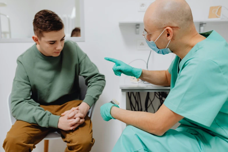 the dentist is listening to the patient for help