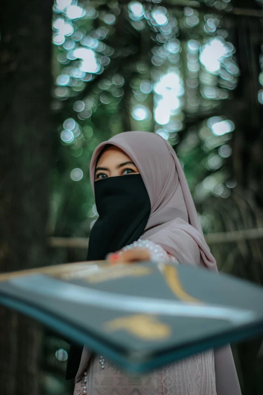 woman wearing an hijab looking over her shoulder