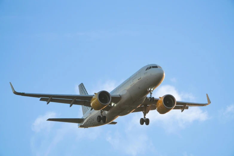 a large airplane in the air, with landing gear down