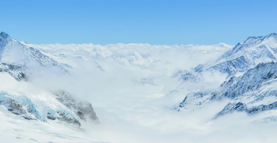 the man is skiing down a very steep mountain