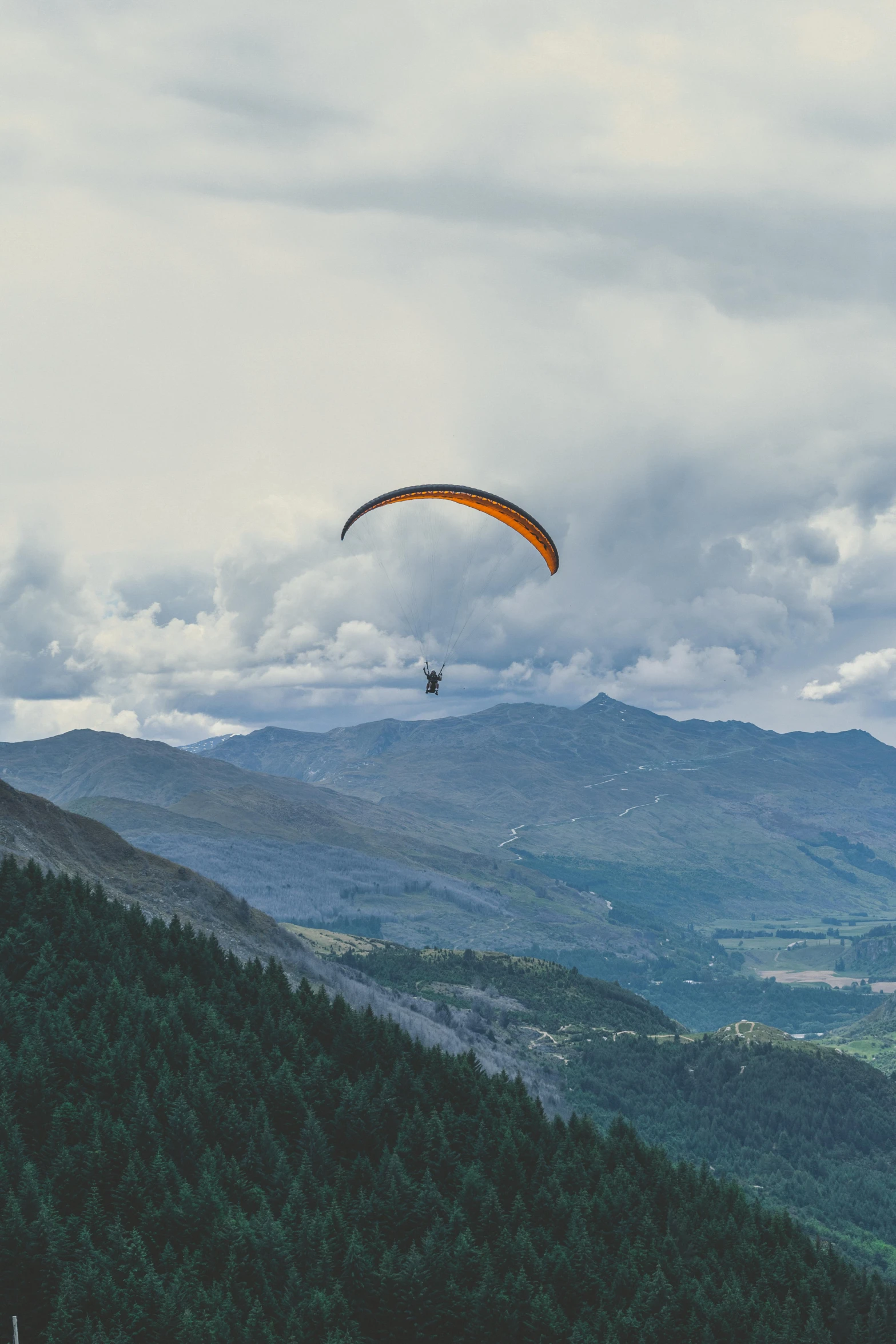 paraglide in the sky over a beautiful valley