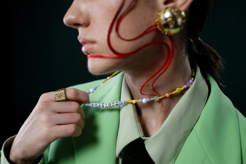 a model displays her face made up as she adjusts jewelry