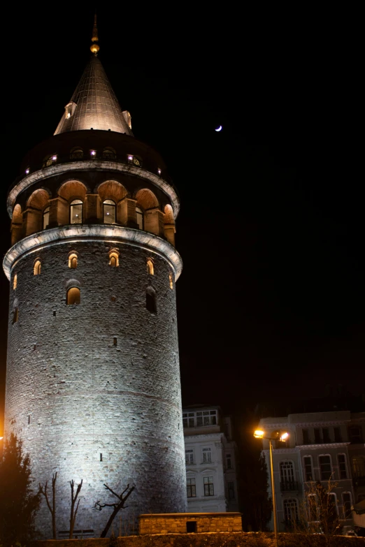 a stone tower sitting at night lit up