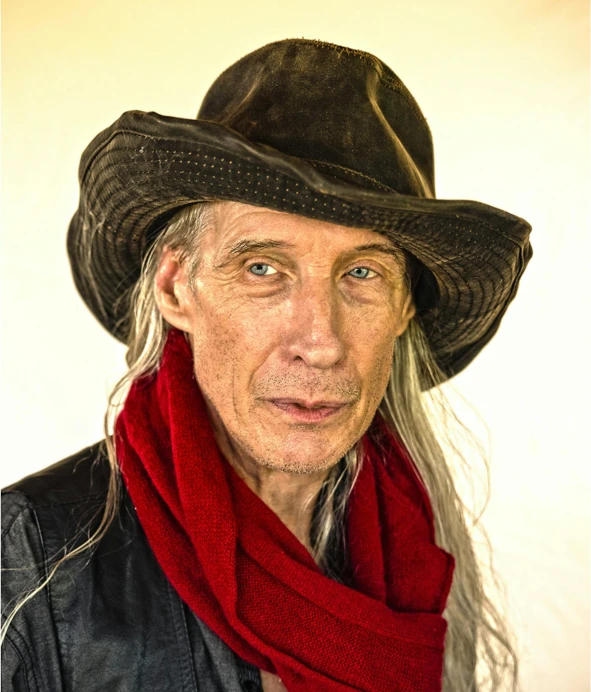 a po of a man in a cowboy hat and scarf