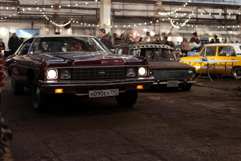 old fashion cars are parked inside an indoor hangar