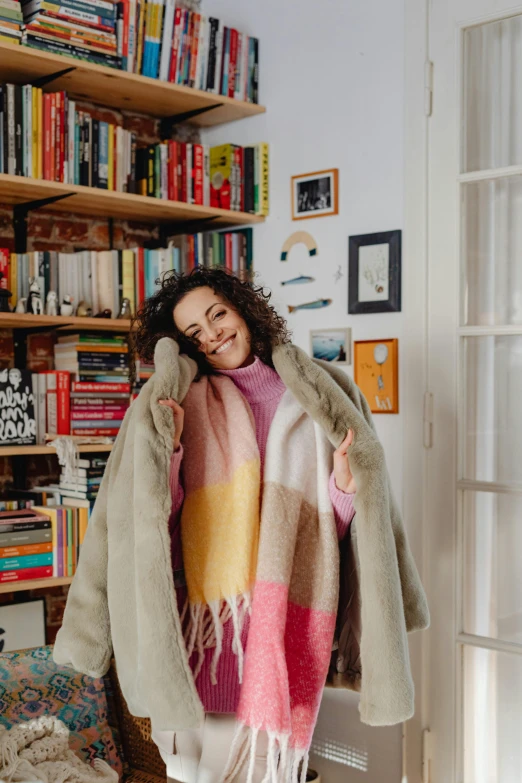 a woman is standing in a room with a blanket