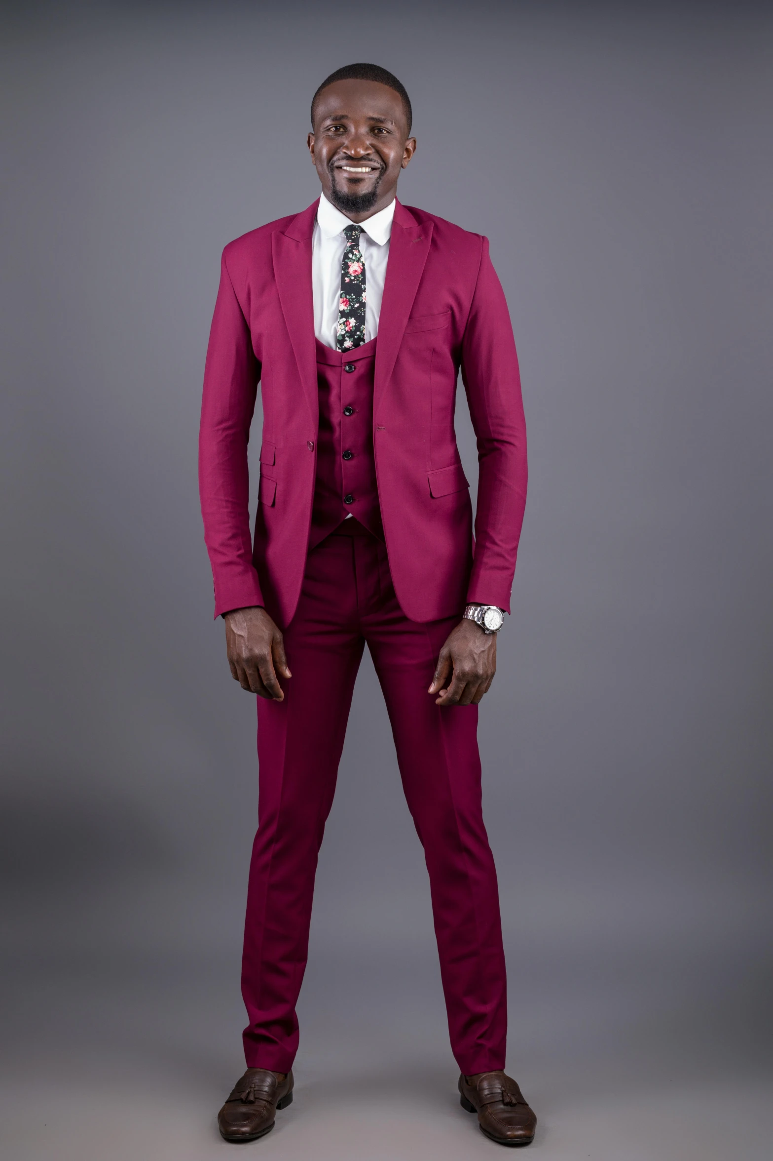 a man in a pink suit is posing for a po