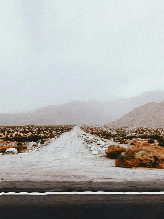 a stop sign in the middle of a desert road