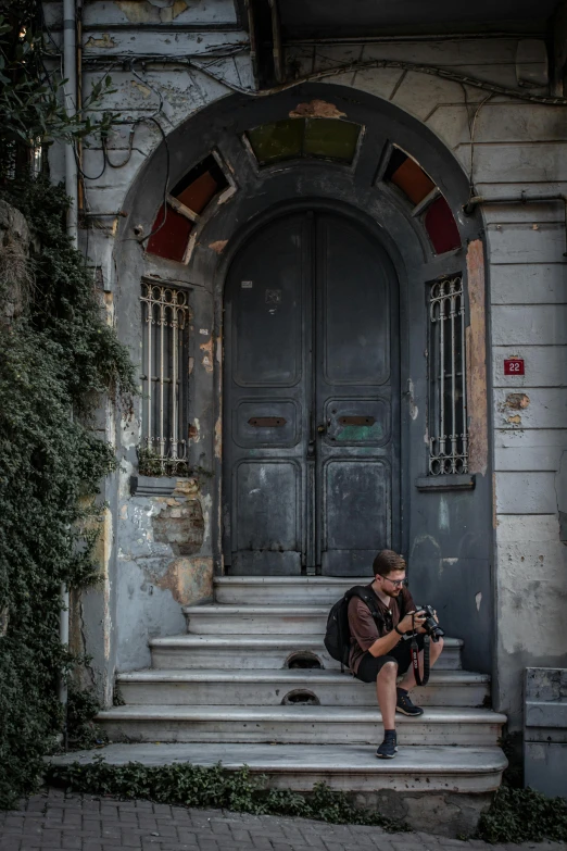 a person sitting on the steps with a camera