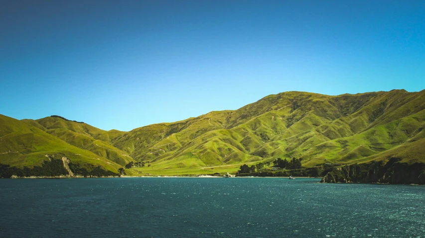 a body of water with hills in the background