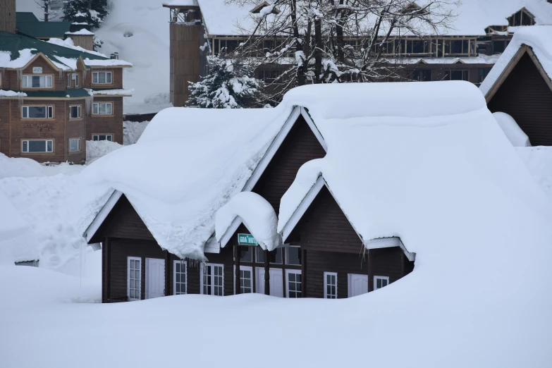 three buildings covered in snow near the snow