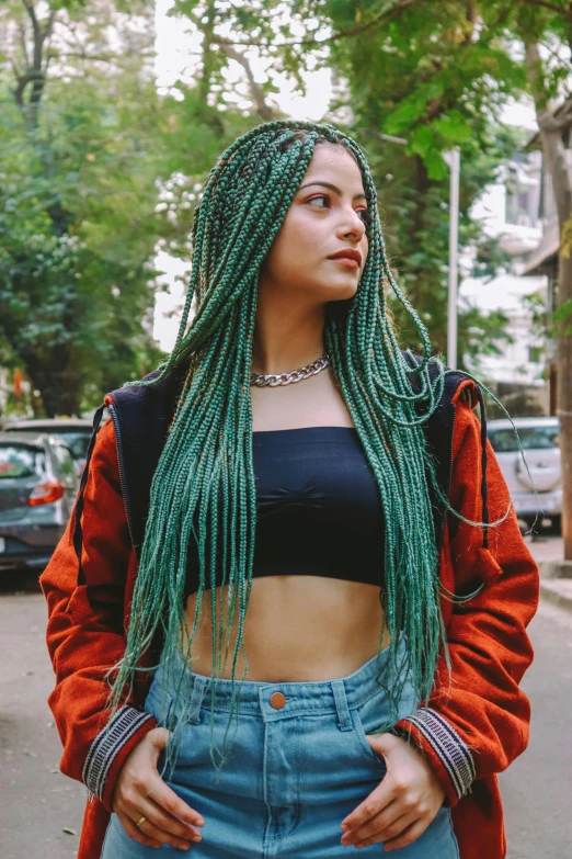 a woman with green hair stands in front of a street