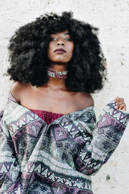 the beautiful woman with afro is posing for the camera