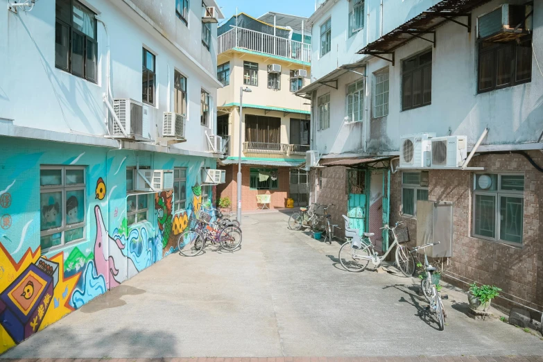 a street with many bikes parked in front of some buildings