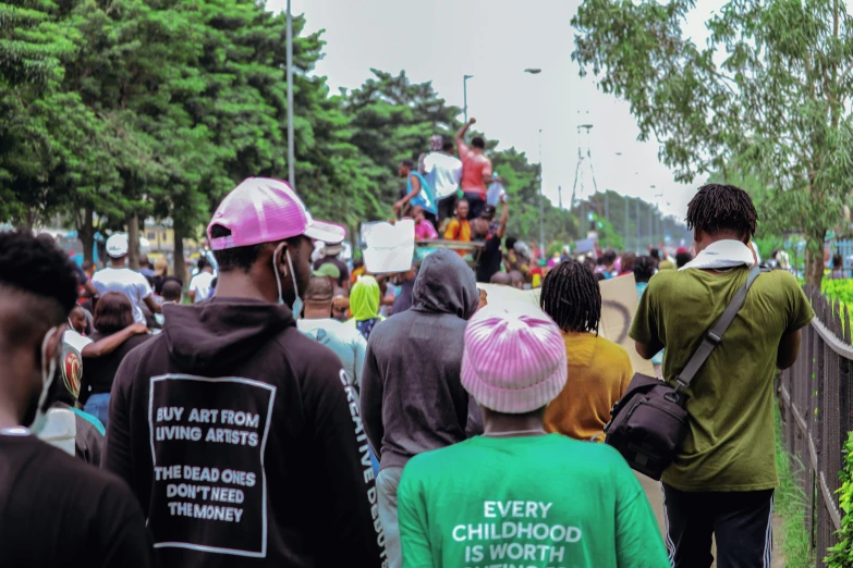 a group of people on a street with signs on their backs