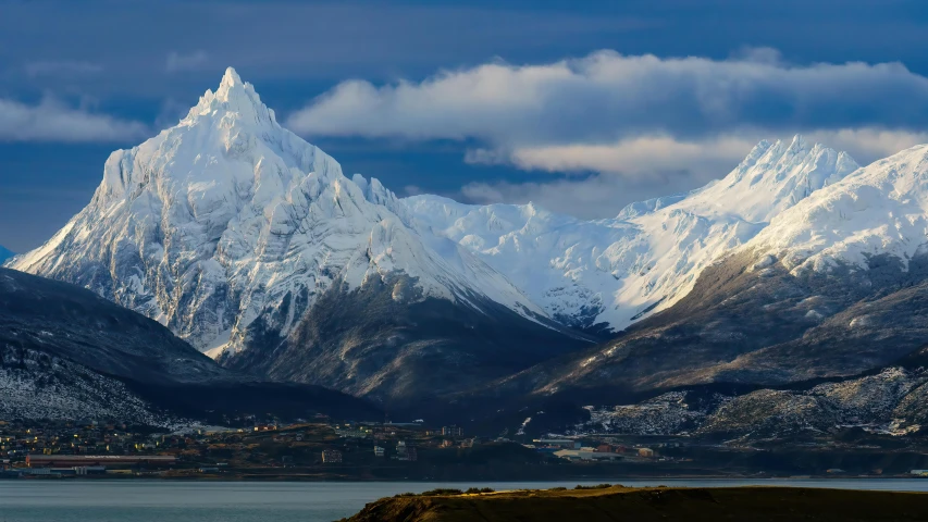 a mountain range is in the distance as it is surrounded by snow