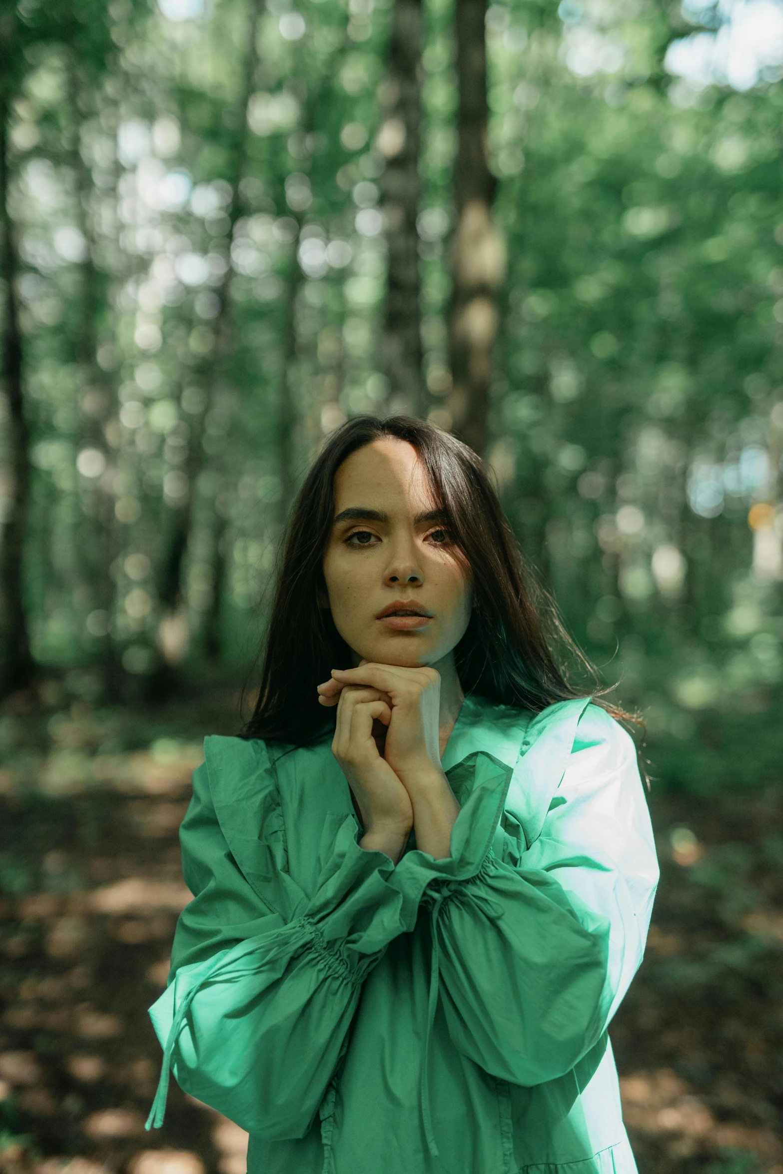 a girl with long hair in the woods