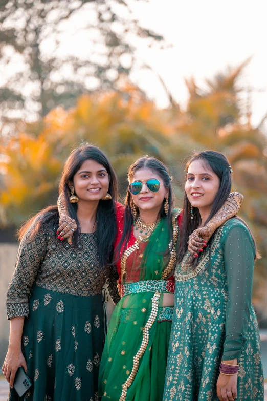 three ladies standing side by side on a sunny day