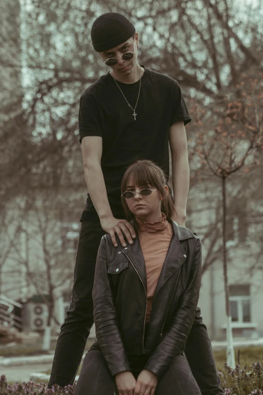 a woman in glasses next to a man wearing sunglasses