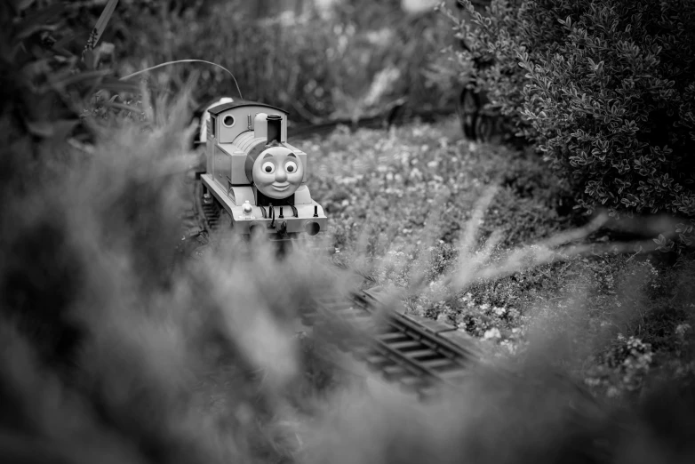 a black and white image of a thomas the train on tracks