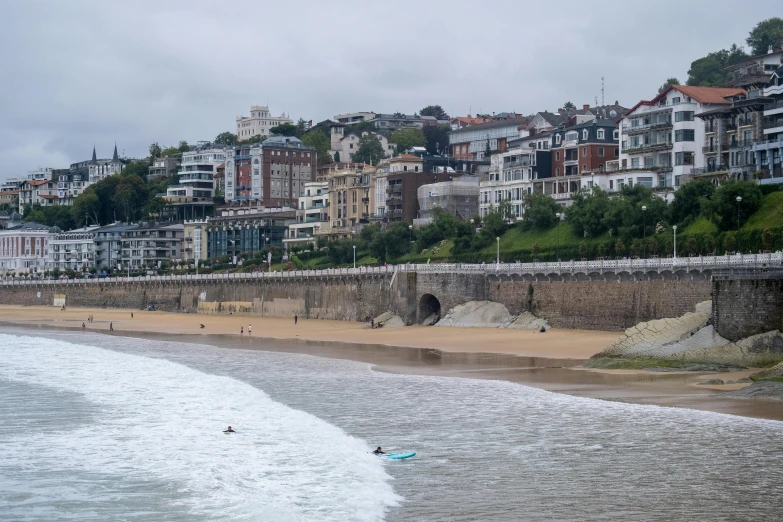 a beach with a body of water next to houses