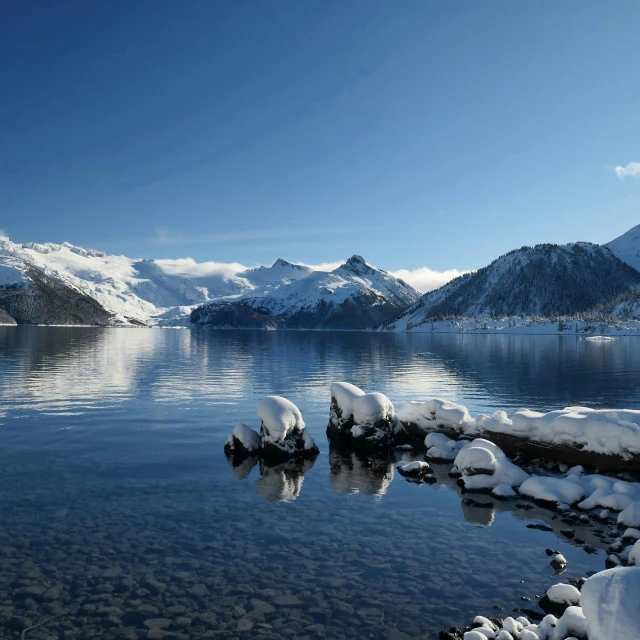 a snow covered mountain lake surrounded by snow