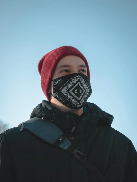 man wearing a mask in front of trees