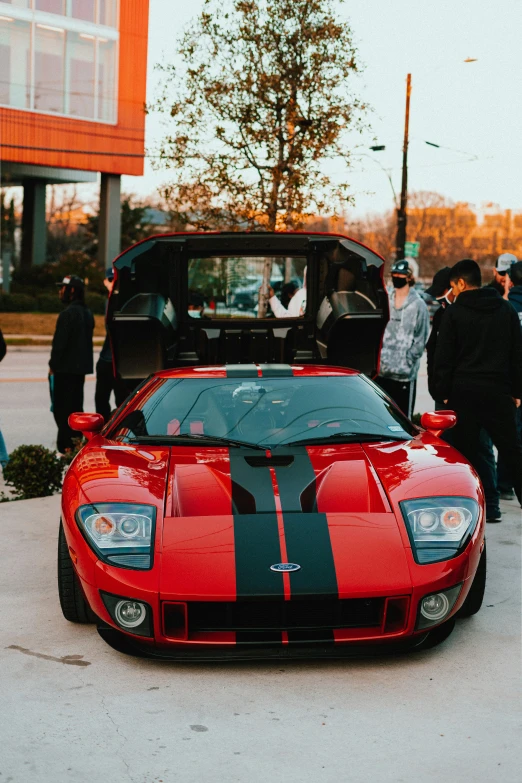 red sports car parked by its owner's side