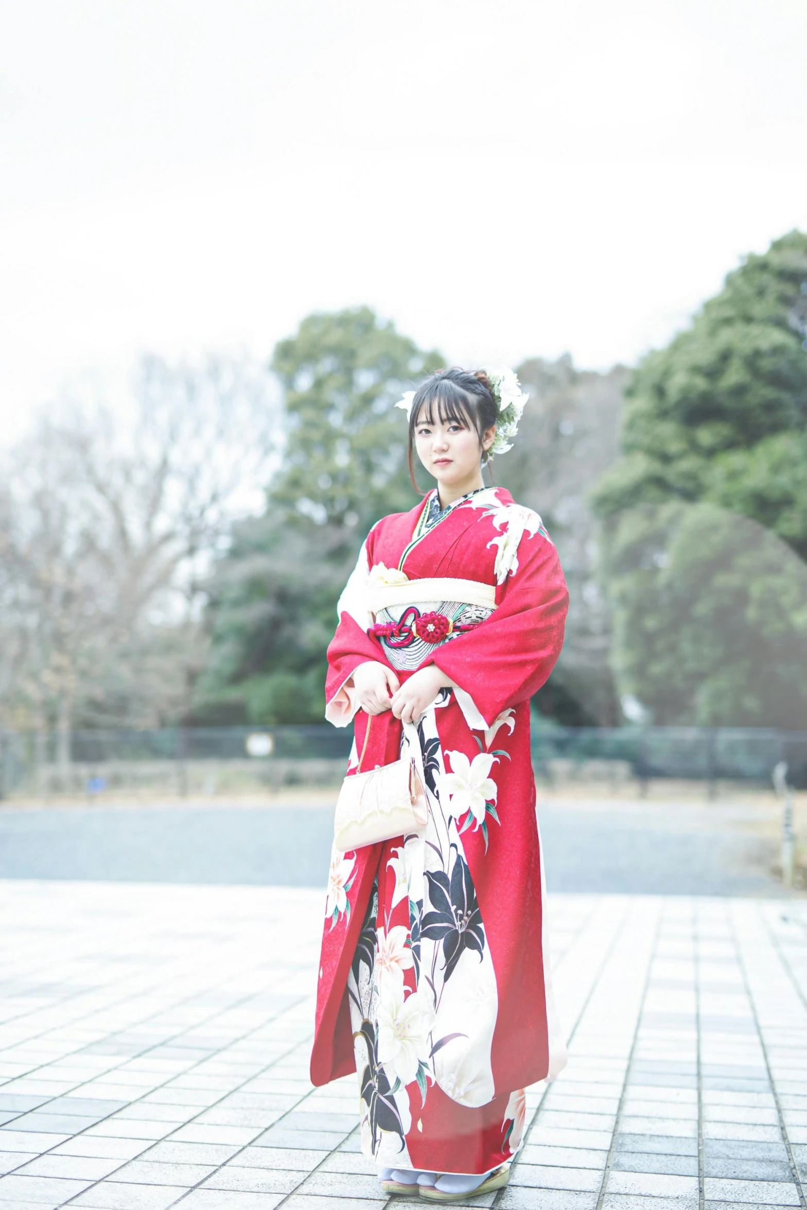 an oriental woman dressed in a kimono posing